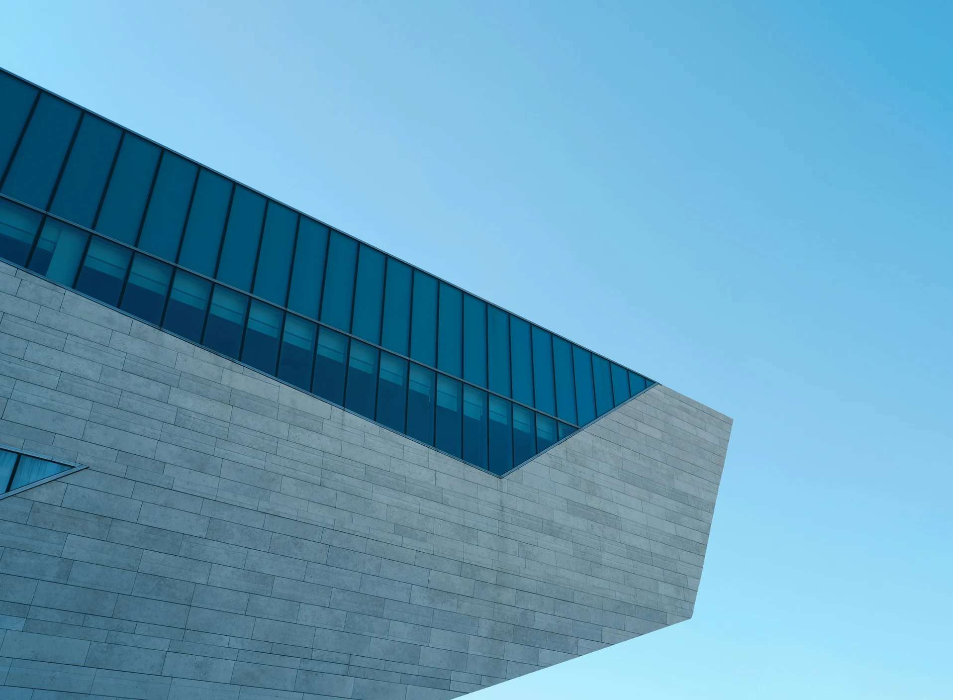 Stone and glass architecture against a bright blue sky — cross-border legal expertise through the international legal network