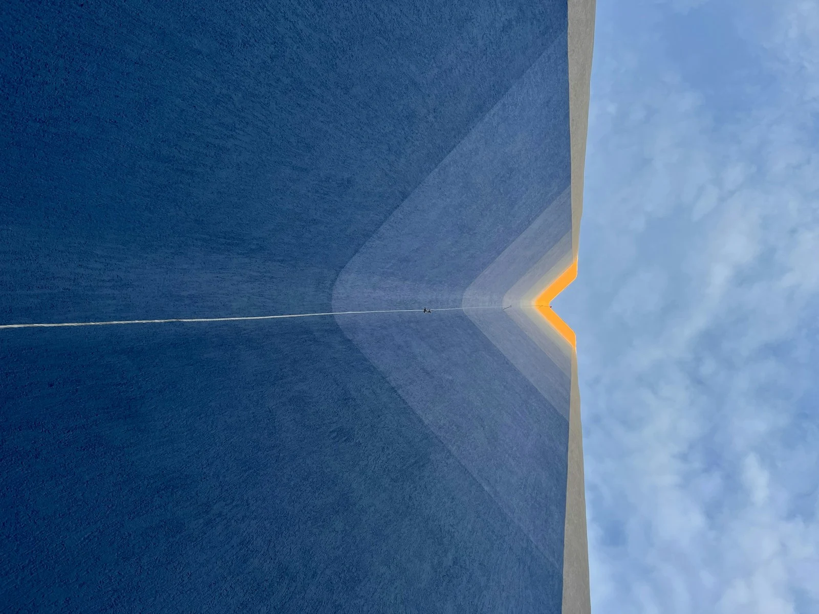 An aircraft passing over the top of a tall building