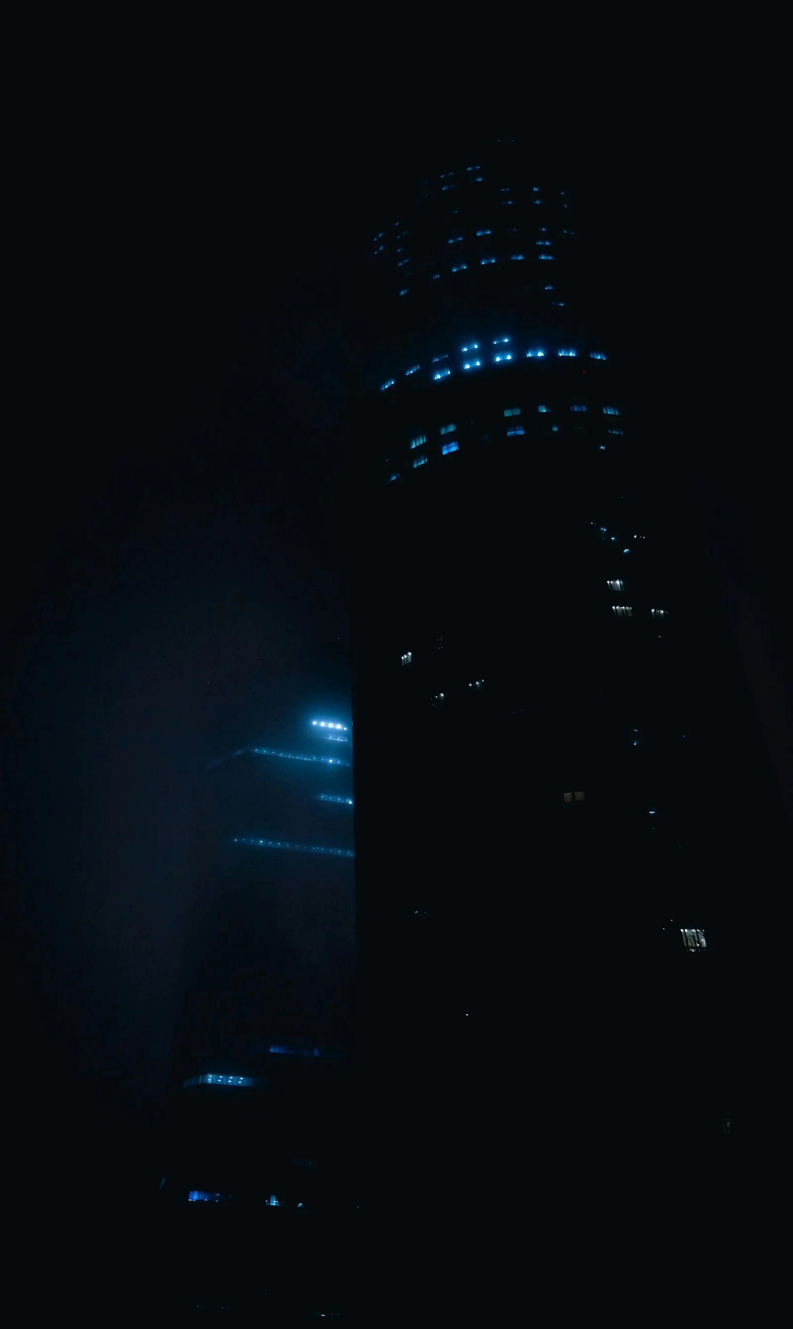A tall building lit up against the dark night