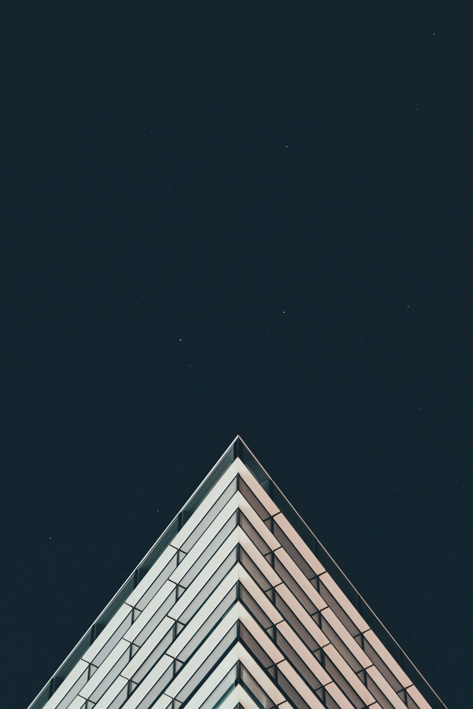 The edge of a white building under a night sky full of stars
